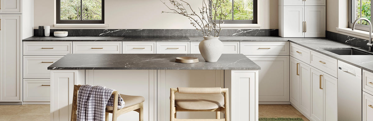Kitchen with white cabinets and a dark stone island